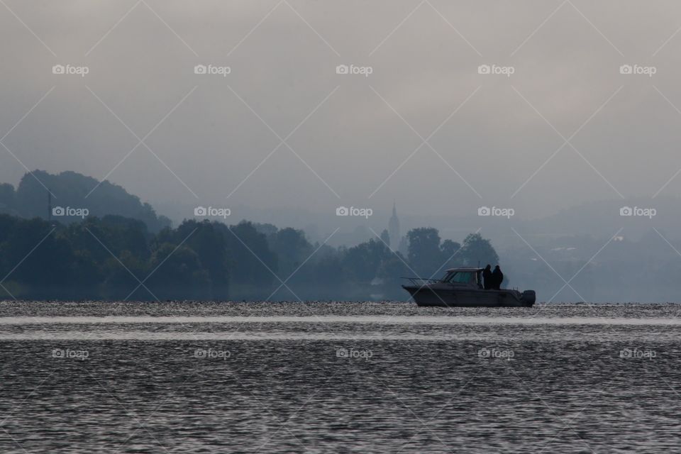 Boat sailing in foggy lake