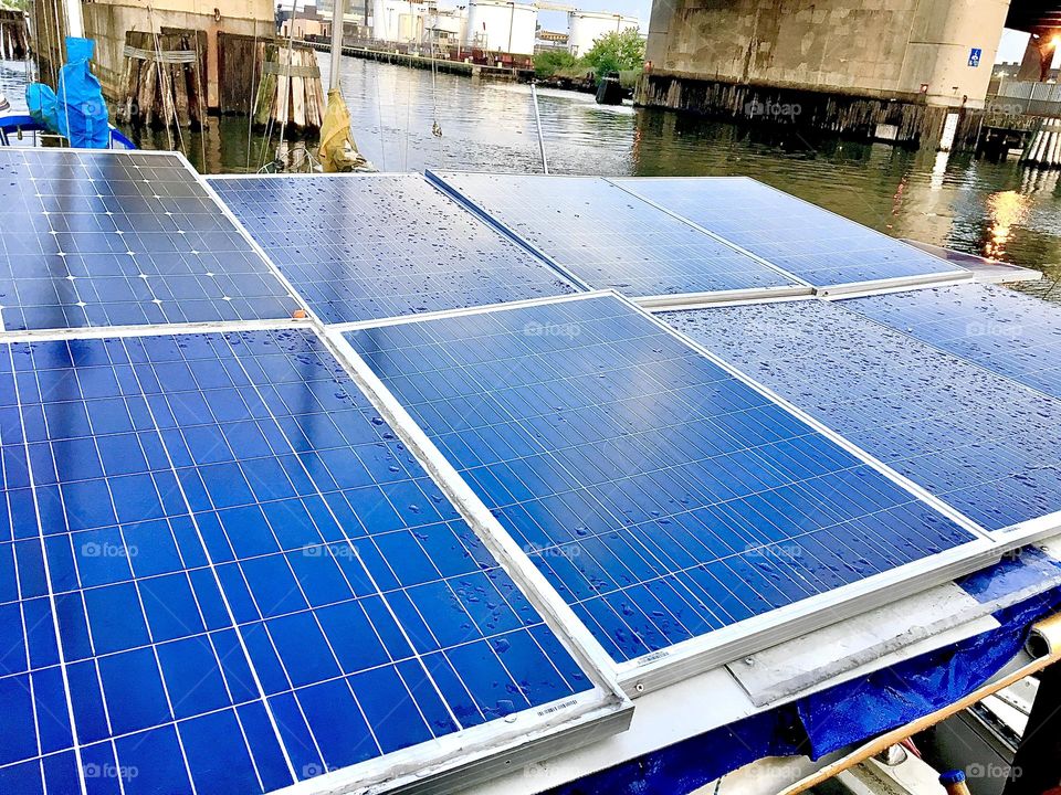 The vibrant blue of the solar panels arranged side by side in two rows to cover the maximum area on the roof of the “Salvation” reflect the light at all angles and absorb the sun’s energy so we can run our appliances. 2021. Hypnotic Productions.