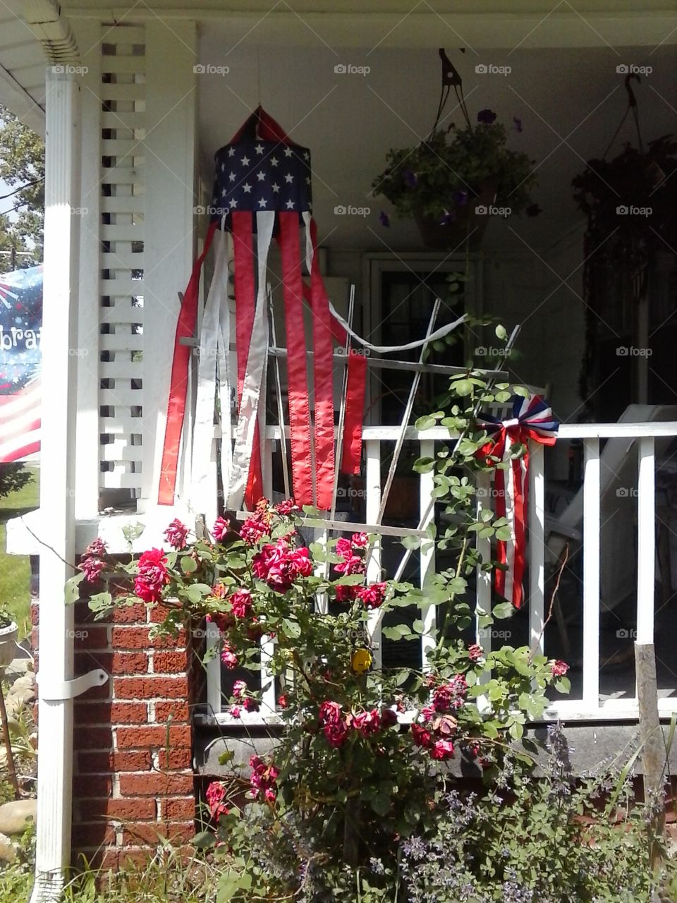 flags and flowers . a porch with flags and flowers 