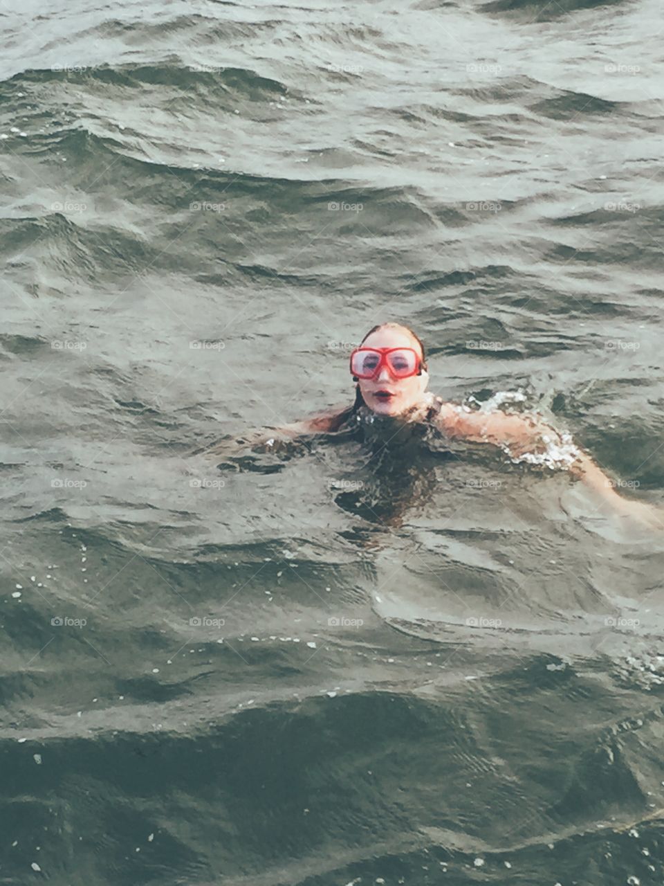 Girl swimming in the ocean