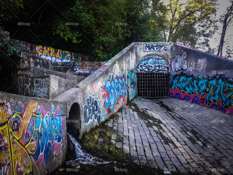 Graffiti decorates a Minneapolis excess runoff water drain. Where Minnehaha Creek and The Mississippi River meet.