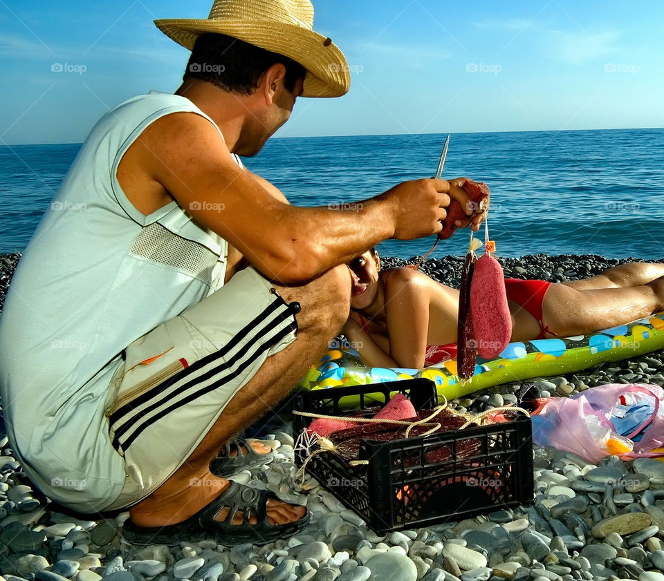 beach trade, basturma, smoked products, holidaymakers, trader, hat, evening, summer, vacation, heat, tan, Sochi, Black Sea, south, stones, beach, coast, horizon, expanse, distance, view