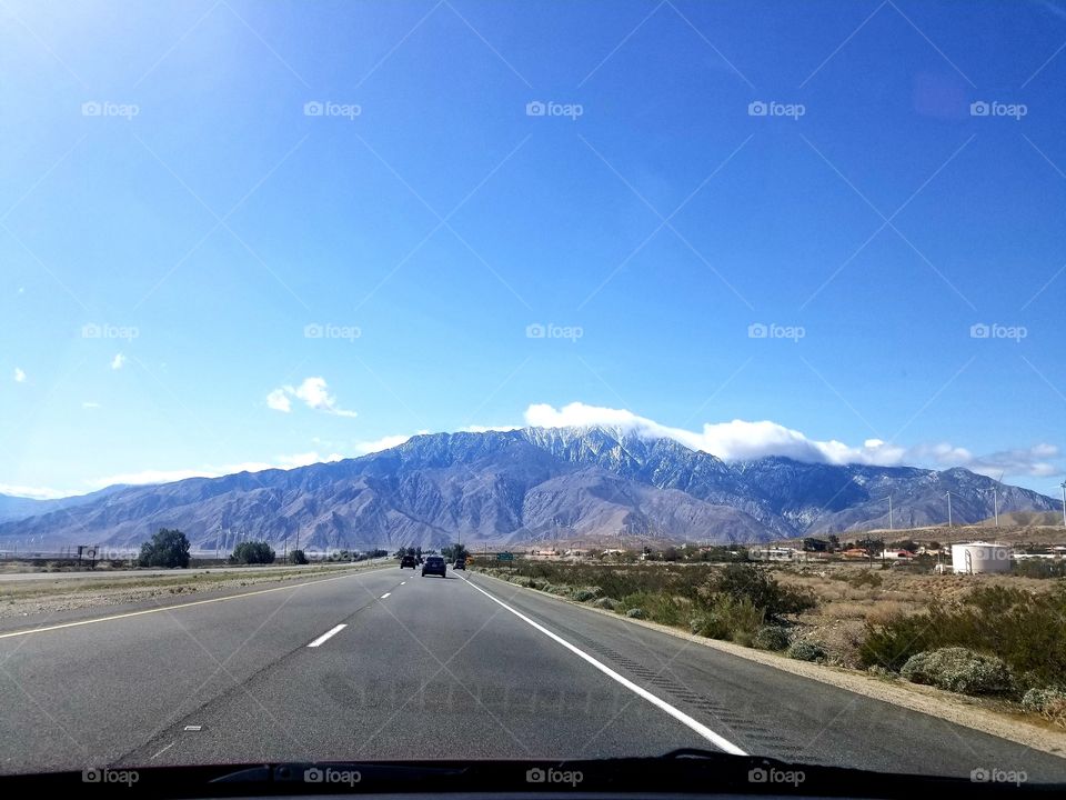 Road Trip I: desert road with mountain views