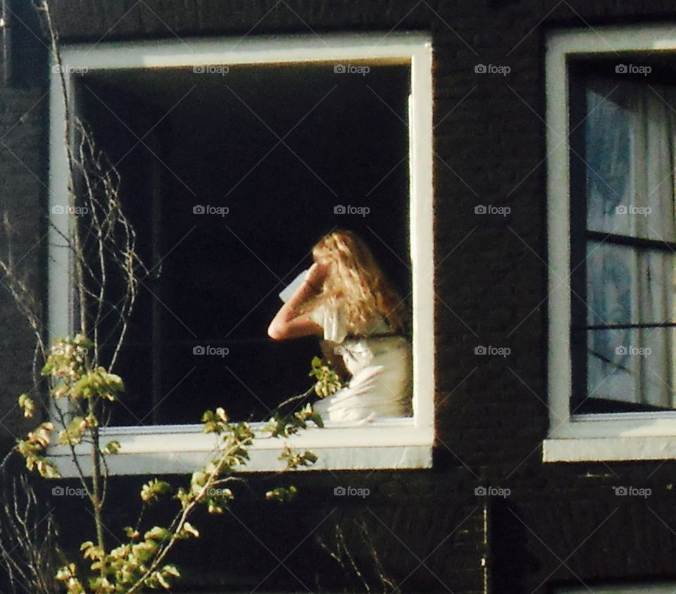 Lady on window ledge