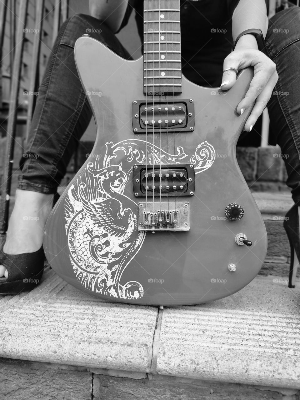 Female sitting with Electric Guitar