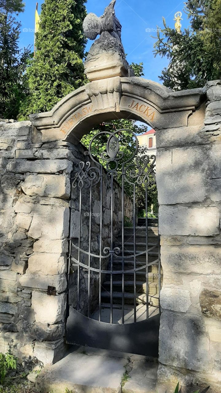 gate in the old stone wall  door to religion