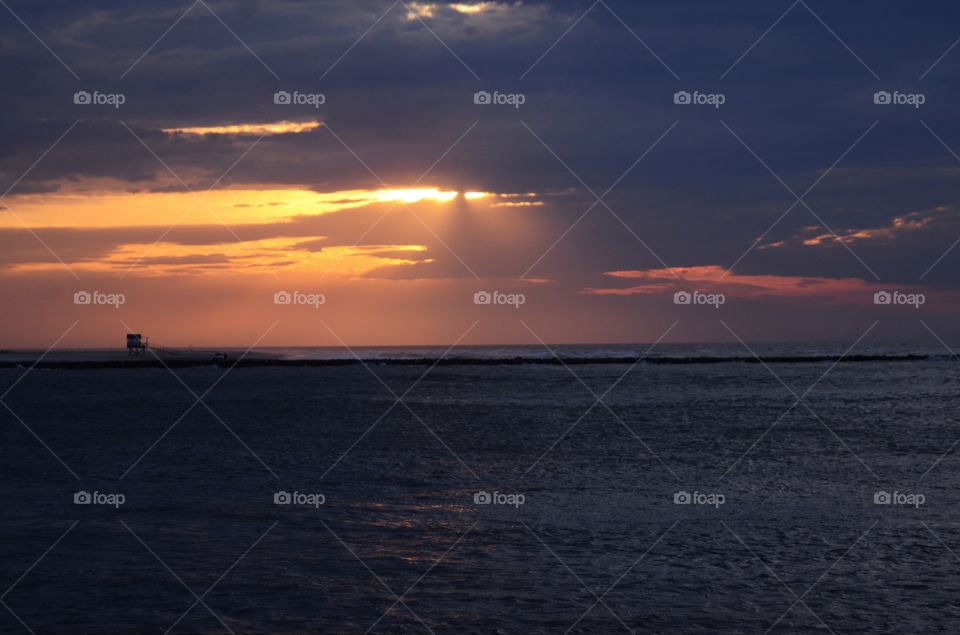 A beautiful sunrise off the horizon of the Absecon bay in Atlantic city lights up the morning sky.