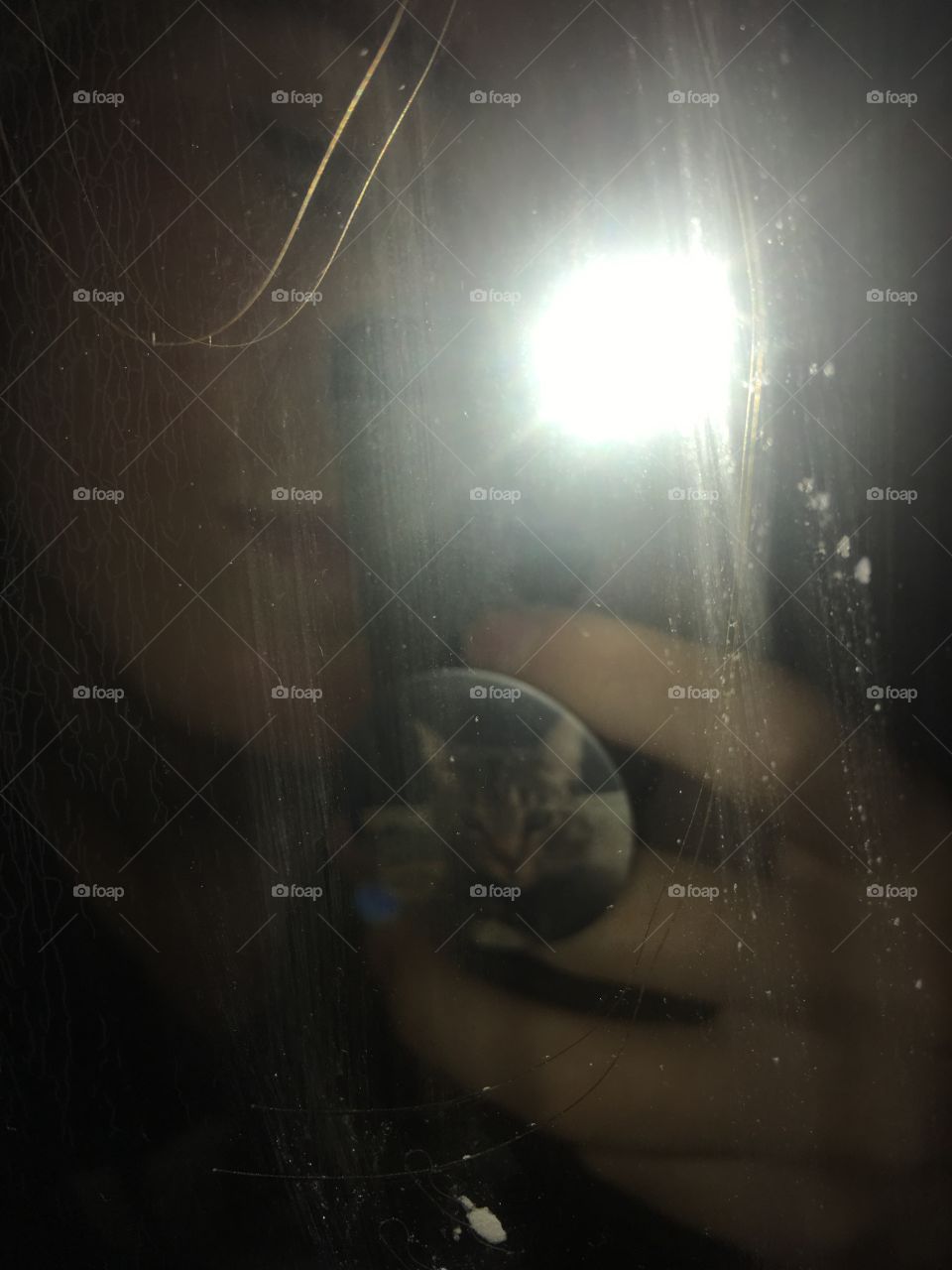 Man taken photo in the mirror with flash and darkness