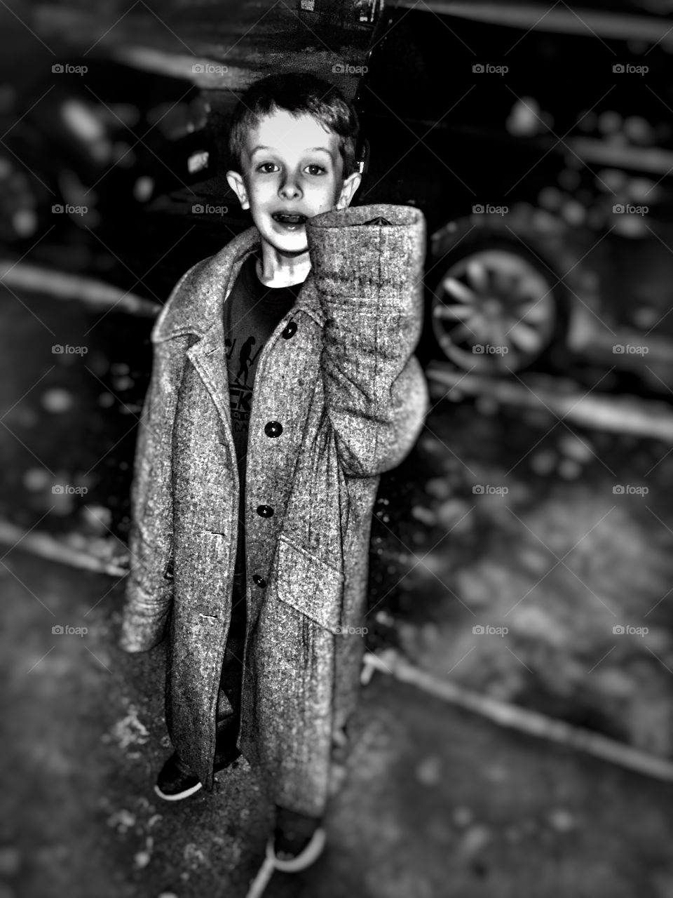 Boy wearing large coat
