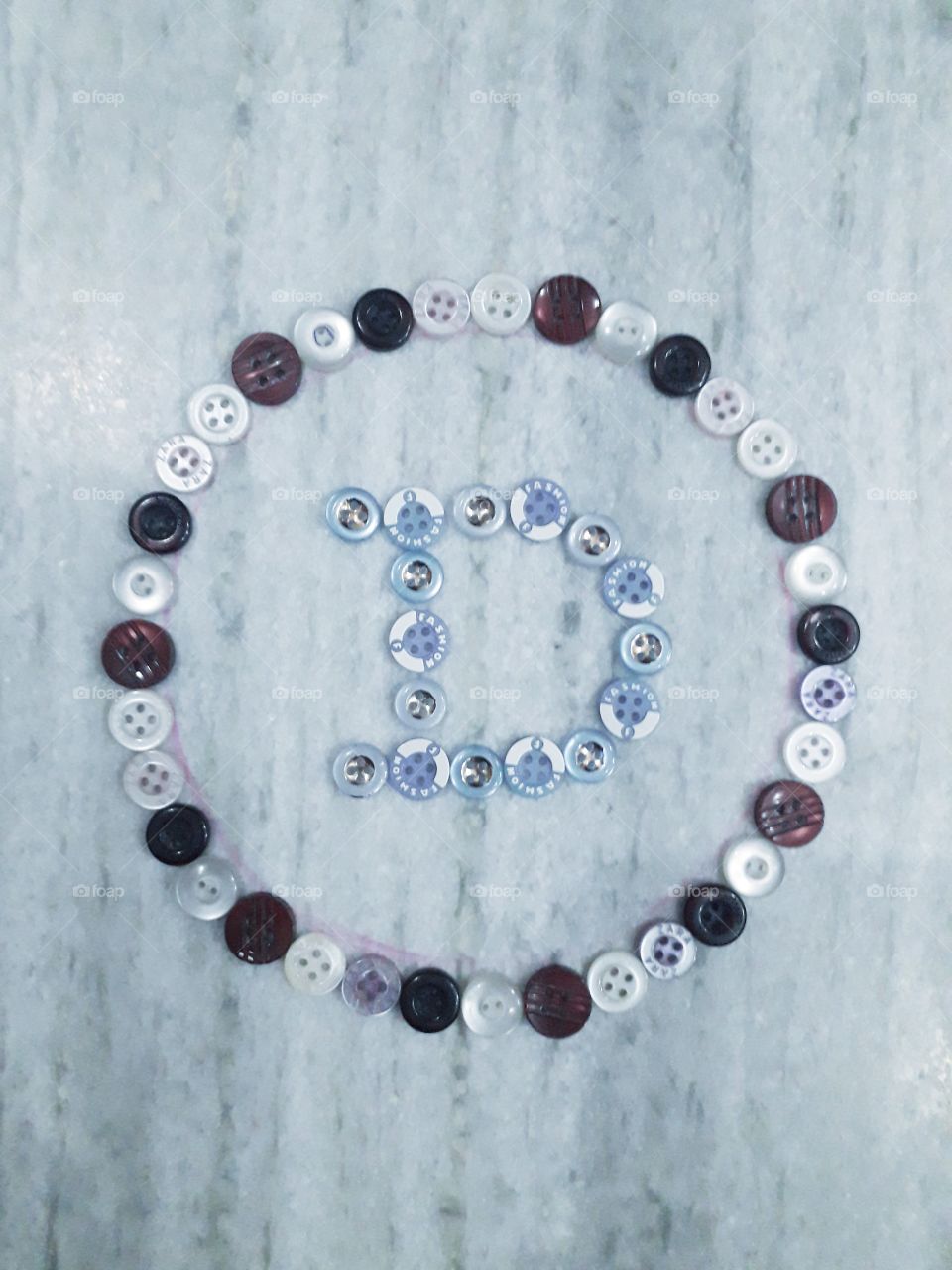 Buttons design on the floor, Alfabet caracter D creat by buttons.