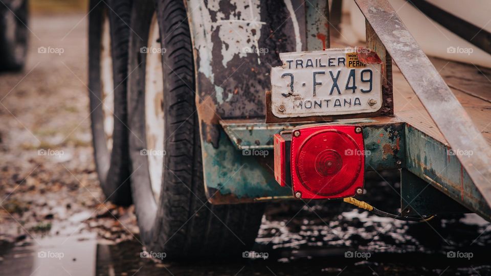 Rustic trailer over muddy yard.