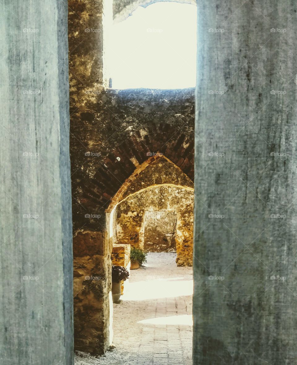 View from outside the Mission through a wood gate.  Spanish Mission architecture - World Heritage Site