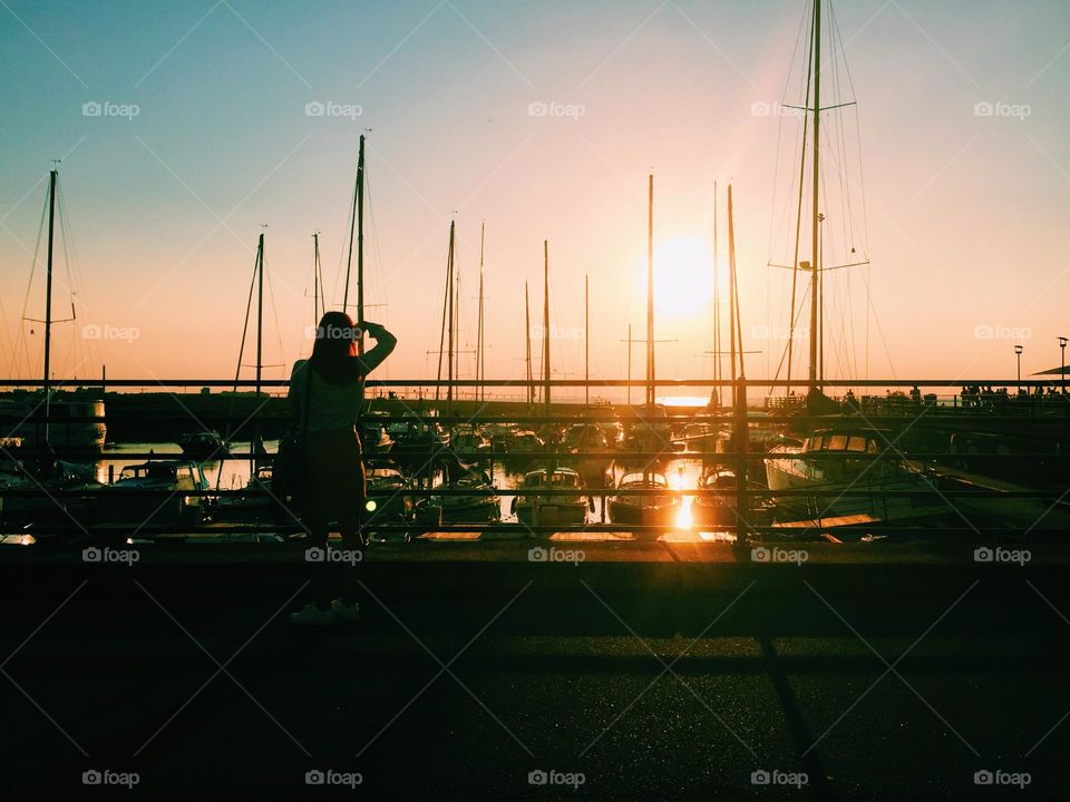 Sailing boats in the sunset at the marina in summer 