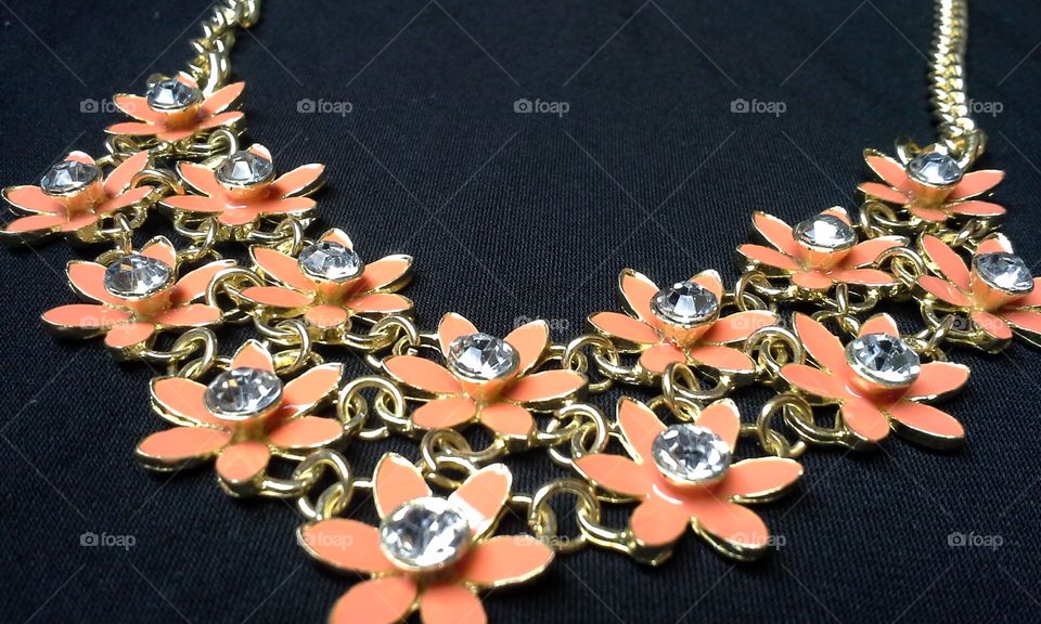 crystal orange flower gold necklace on black polyester