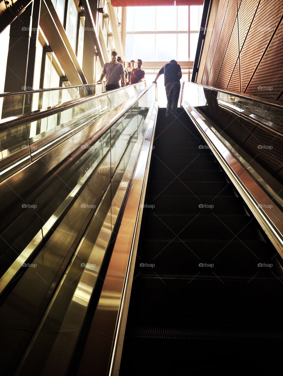 People in a distance on escalators 