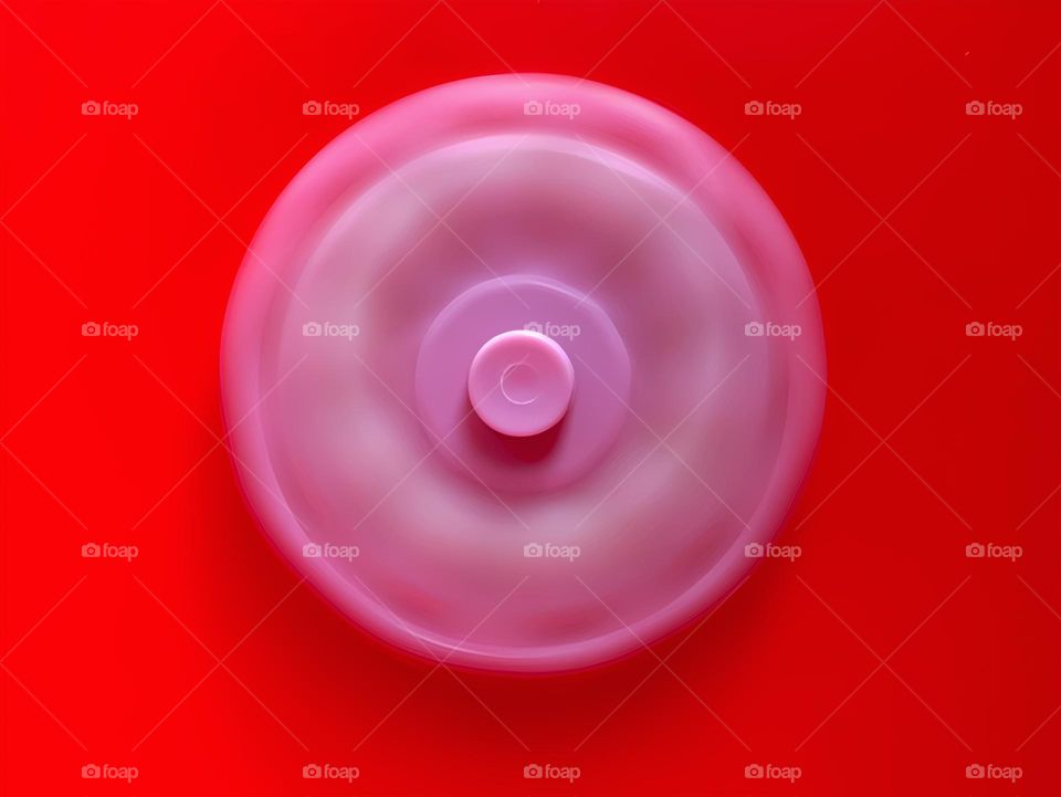 Multicolor Fidget Spinner Time In Motion Long Exposure On A Red Background.