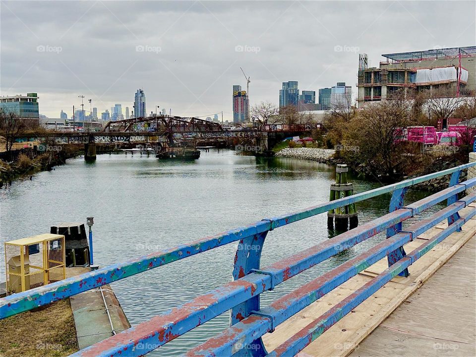This is the “Borden Avenue Bridge” over “Dutch Kills” in LIC, Queens. The arched structure across the water is an old railroad bridge. I am walking in the direction of “Newtown Creek” and the “Pulaski Bridge”. 2023. Hypnotic Productions