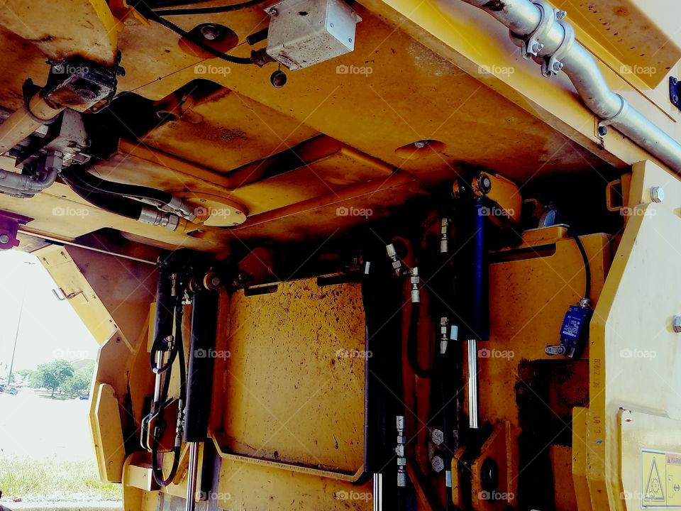 A closeup look at the under belly of a large construction machine.