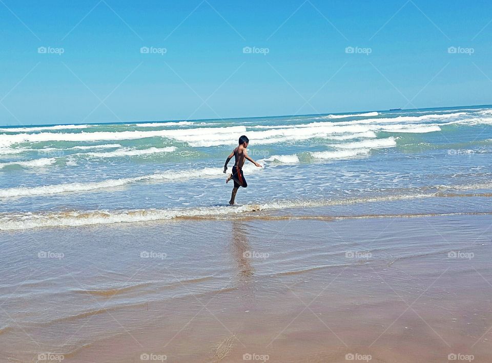 A boy running at beach