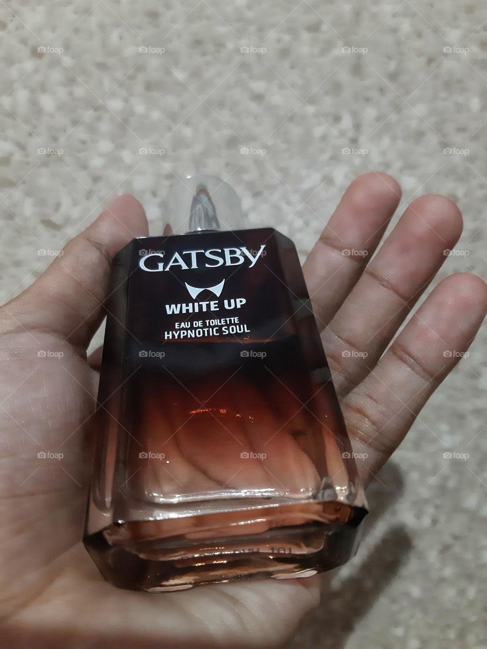 A body perfume glass bottle in a hand named Gatsby