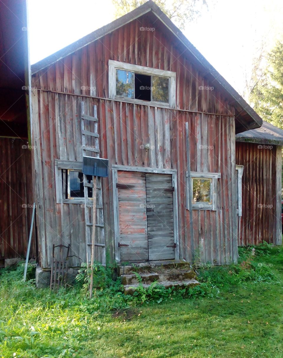 Sunny reflection on the windows of abandoned house at countryside