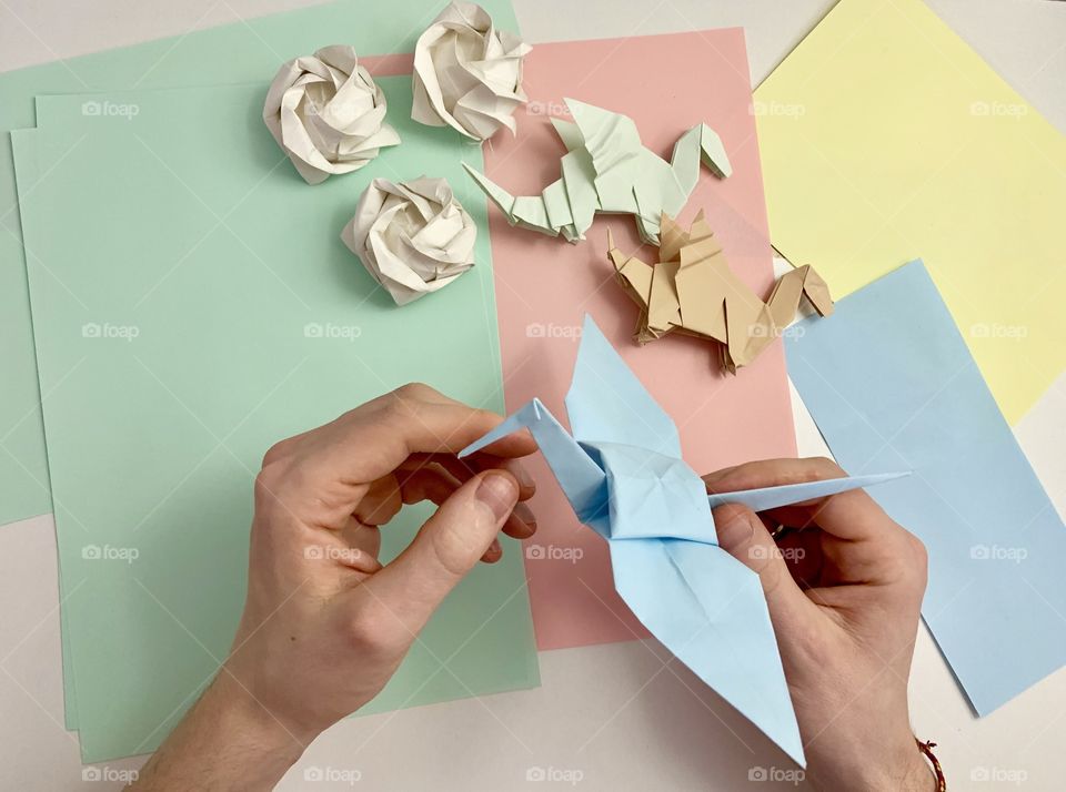 Man is making origami 