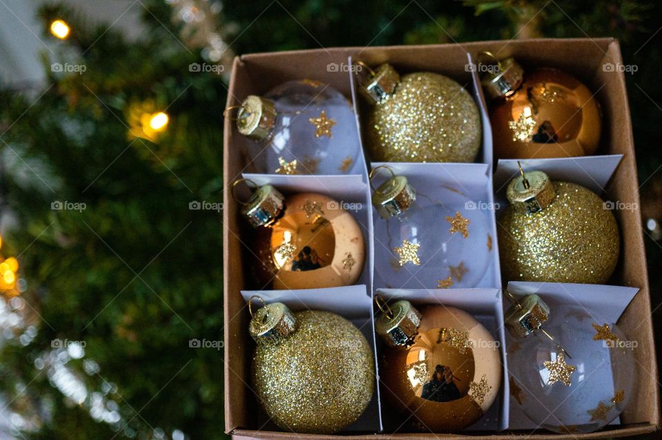 Golden Christmas balls before hanging them in the Christmas tree