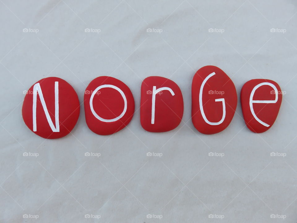 Norge, norwegian name of Norway, scandinavian country composed with red colored and carved stones over white sand