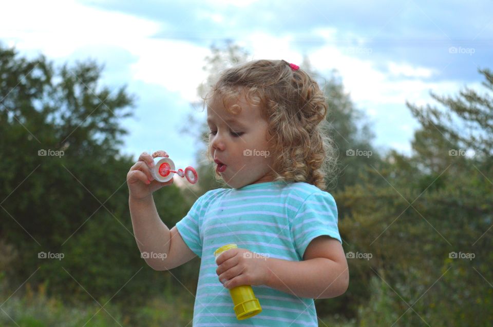 Girl trying to makes bubbles