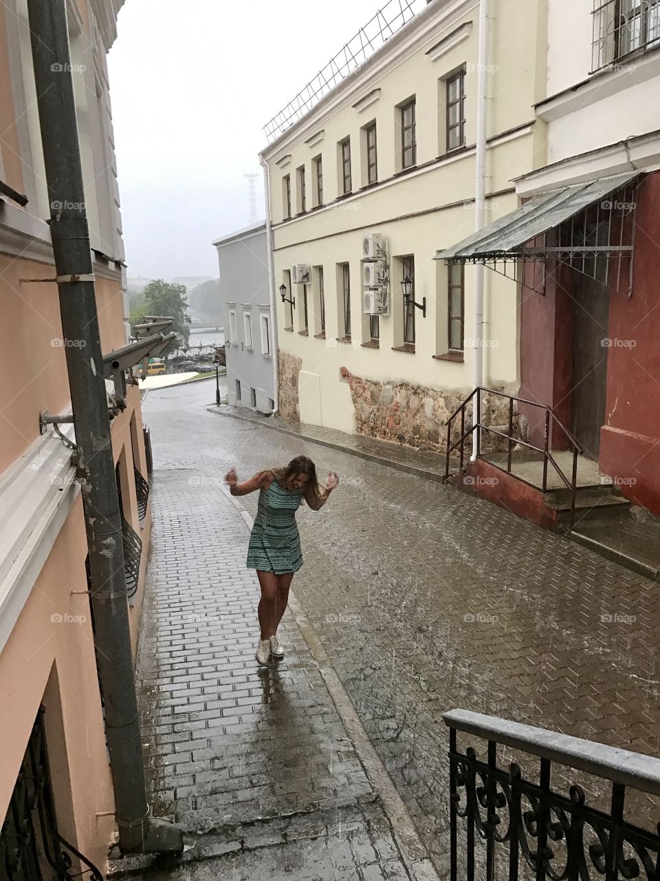 Girl dance under the summer rain 