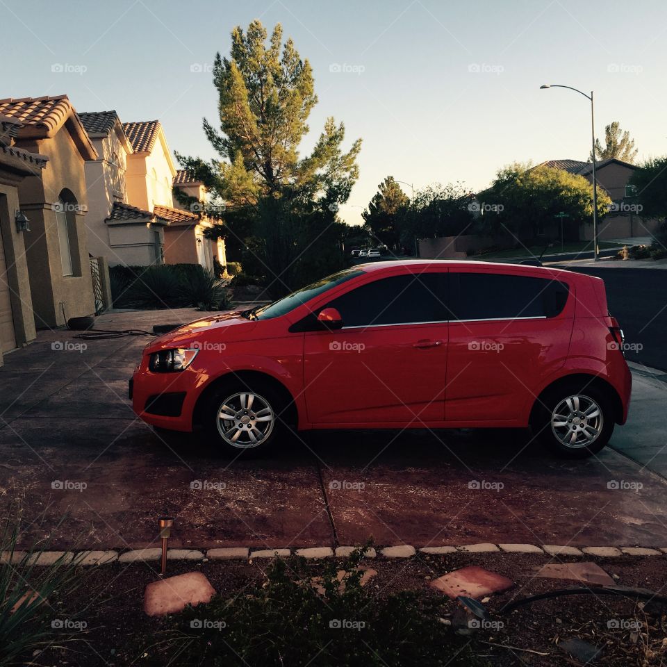 Red car . 2015 chevy sonic with dark tinted windows