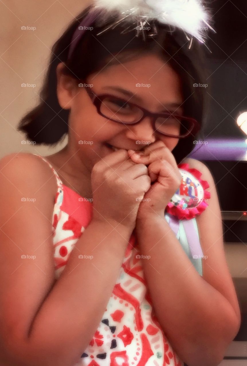 Asian little girl in eyeglasses looking at camera