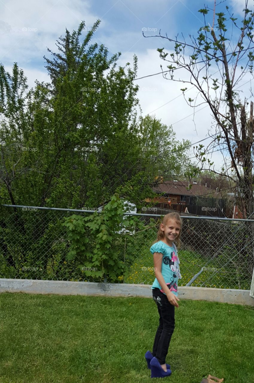 Smiling girl standing in park