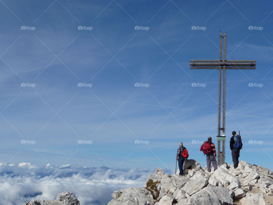 Group of people standing near cross