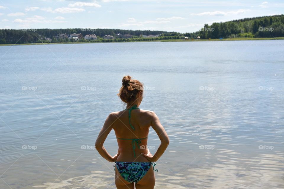 girl in swimsuit resting on a lake beautiful summer landscape