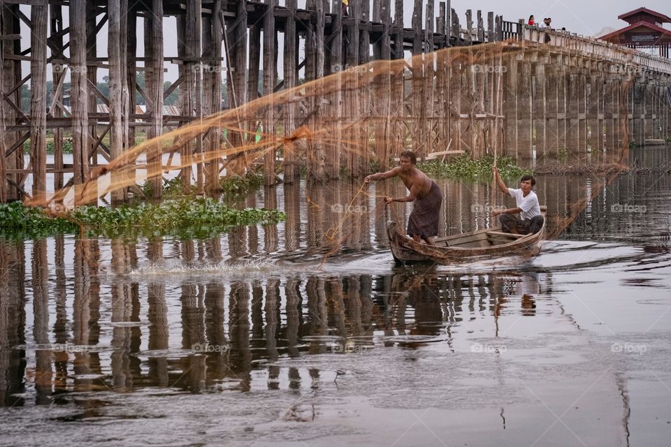 Local life style of fisherman in Early morning at Uben bridge , the longest wooden bridge in the world.