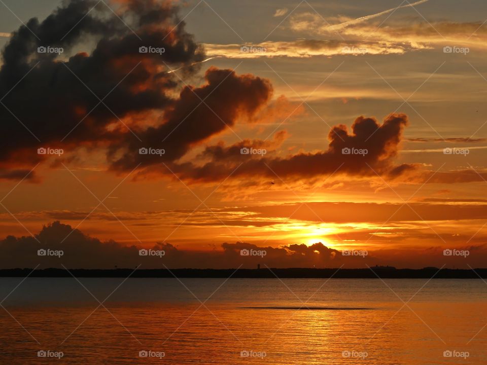 Sunset through the passing clouds  - Sunsets with their clearly delineated endings are difficult not to interpret as the last act, the final curtain call