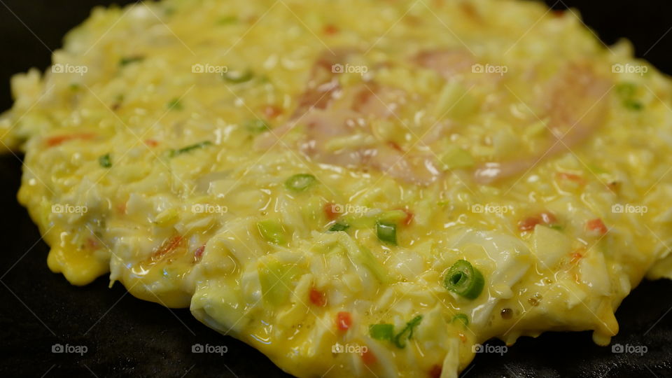 Okonomiyaki the Japanese pancake. meats and veggies mixed in a batter cooked in the shape of a pancake