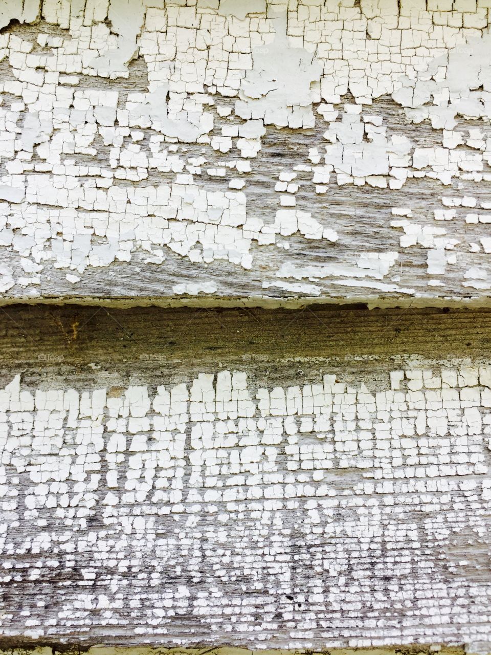 Peeling off white paint on wood