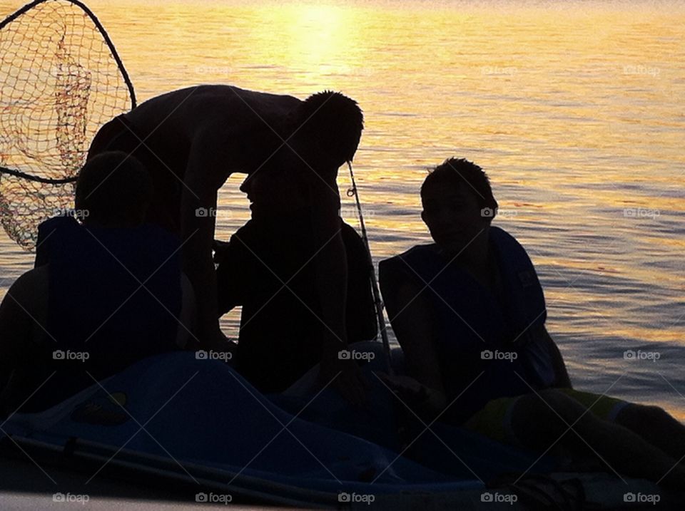 Teenage boys Fishing at late sunset silhouette. Teenage boys Fishing at late sunset silhouette