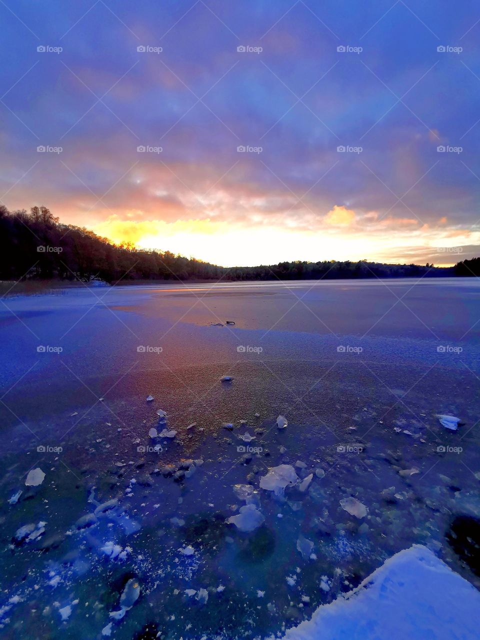 Sunset at the frozen lake