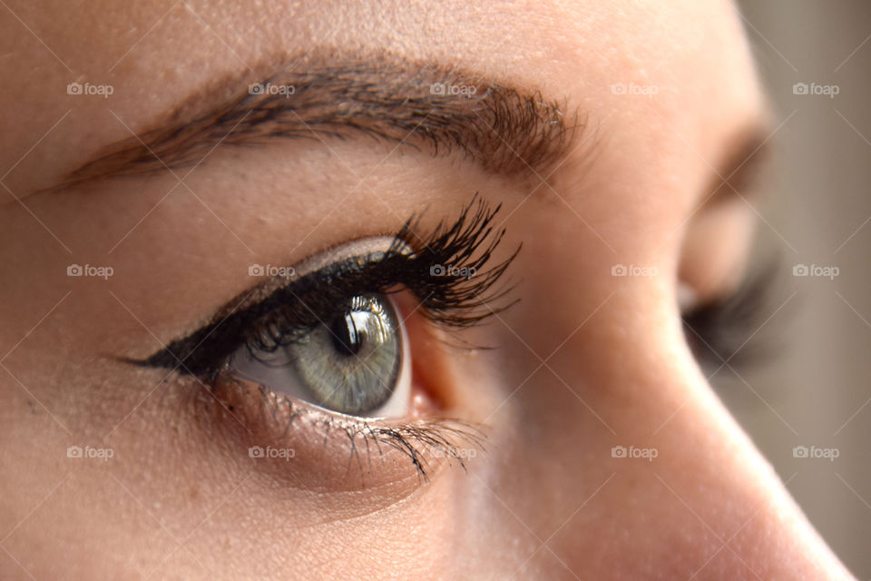 Magical iris, right eye profile of beautiful female blue eyes