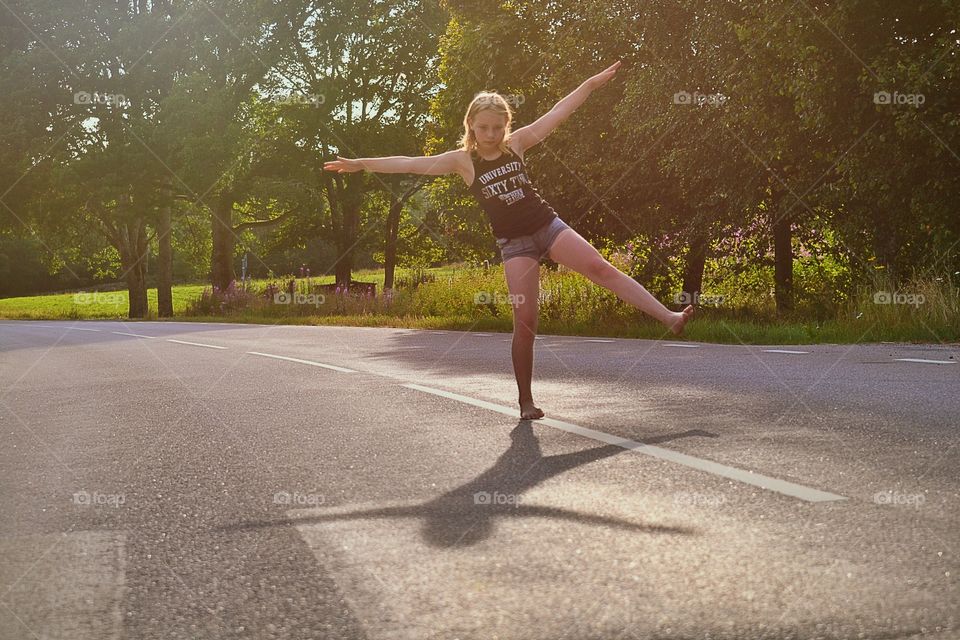 Balancing. Girl try to balance on the road