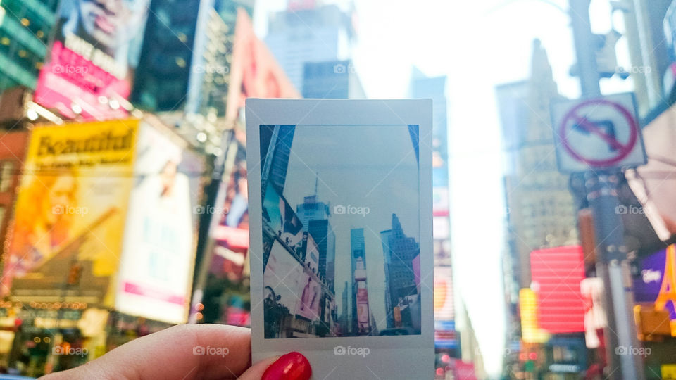 Women holding an polaroid photo