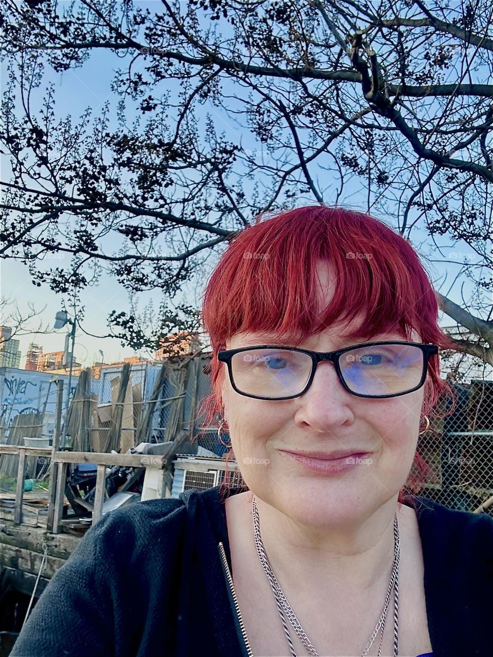 This is me, “Petra Schiller” a.k.a. “Maxine Firefox” standing outside on the front deck of “Salvation”, the “28 ft 1969 Luhrs” cabin cruiser that is home to myself and partner “Timothy Trespas” on a sunny evening in March 2024. Hypnotic Productions