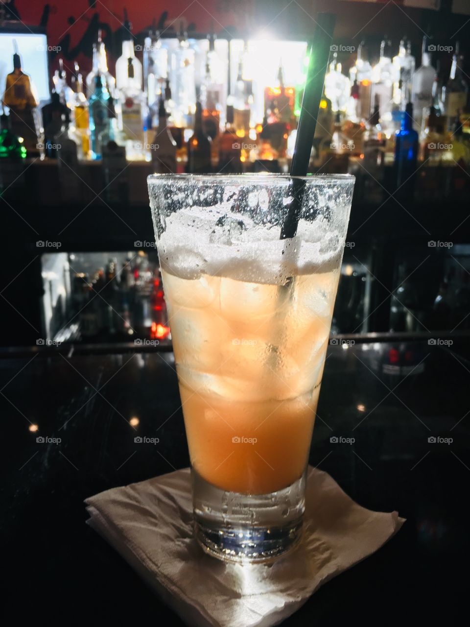 Sunshine shining through liquor bottles at the bar on my drink