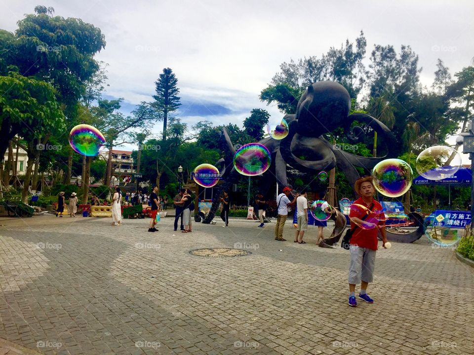 Bubble blowing to create beautiful spheres of color on Gu Lang Yu Island @ Xiamen, China 