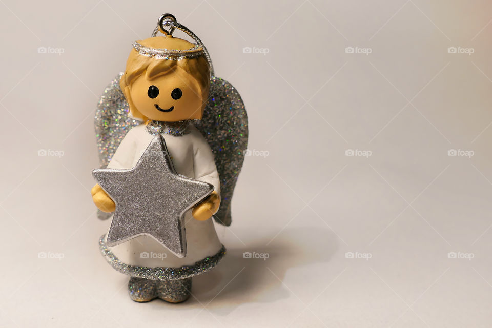 Figurine of little white angel holding a star