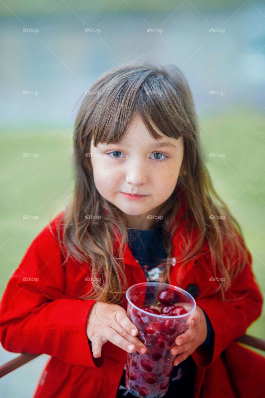 Girl eating cherry  