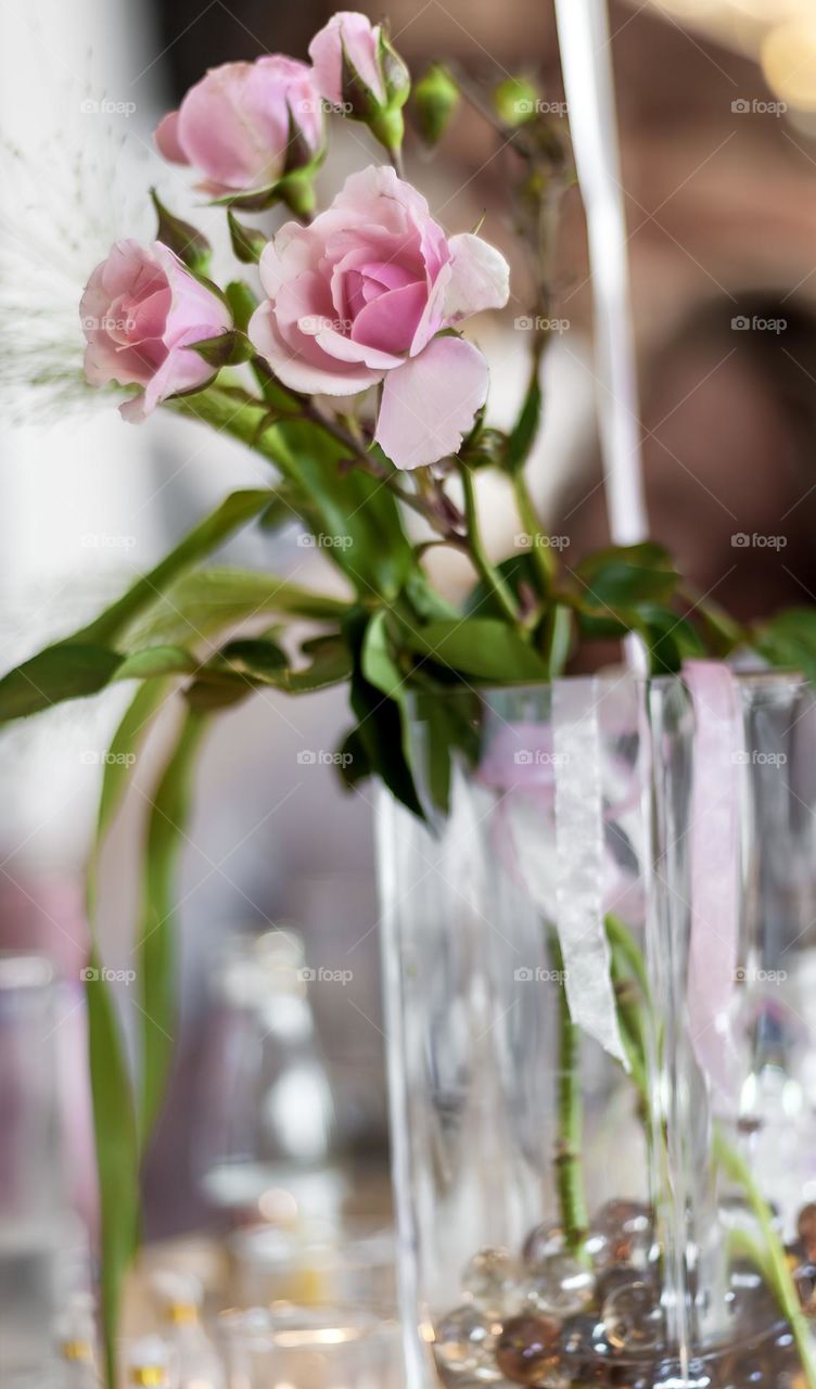Soft pink roses form part of a wedding table display
